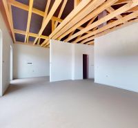A workroom in a family house with a wooden ceiling and white walls.