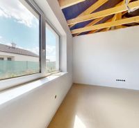 Interior in a family house with a large window and a view of the garden.