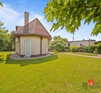 A cottage in Vojka nad Dunajom surrounded by a landscaped garden with trees and a gazebo.
