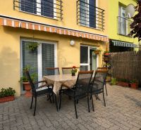 The terrace of a family house on Hrabová Street in Hamuliakovo with outdoor seating and an awning.