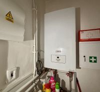 Gas boiler and first aid kit in the utility room of a 3-room apartment.