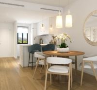 Dining area with a round table and wood-patterned flooring in a 3-room apartment.