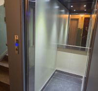Elevator open on the ground floor in an apartment building.