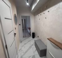 A hallway in a 3-room apartment with ceramic tiles, storage space, and lighting.