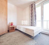 A bedroom with simple furnishings, a single bed, and large windows in a 3-room apartment.