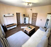 Living room in a family house with a sofa, table, and floor with a wooden decor.