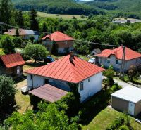 A family house in Slanská Huta on Slanská Huta Street surrounded by greenery and hills.