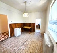 Living room in a family house with ceramic flooring and a pendant light.