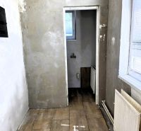 Interior of a family house with a wooden decor floor and plastered walls.