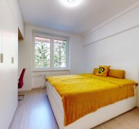 A bedroom with wood-patterned flooring, white furniture, and yellow bedding in a two-room apartment.