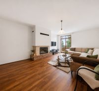 Living room in a holiday apartment, cozy sofa, fireplace, wooden decor flooring.