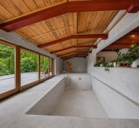 Interior of a holiday apartment with an empty pool and wooden decor flooring.