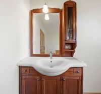 Bathroom cabinet with sink and mirror in the Recreational Apartment.