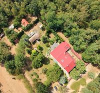 Aerial view of a recreational apartment in Trnava surrounded by greenery and trees.