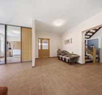 Spacious hallway with tiles, a sofa, and a built-in wardrobe in the Recreational Apartment.