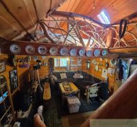 A rustic interior of a family house with wood, decorative plates, and cozy seating.