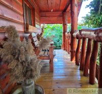 Wooden porch of a family house in Lehota with rustic details and natural decorations.