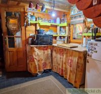 Rustic kitchen in a family house with wooden decor and traditional decorations.