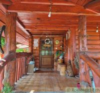 A log cabin in Lehoty with traditional decorations and a wooden-patterned floor.