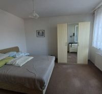 A bedroom in a 3-room apartment with a bed, a wardrobe, and a picture on the wall.