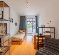 A children's room with beds and a wooden decor floor in a 2-room apartment.