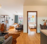 Interior of a 2-room apartment with a wooden decor floor and comfortable seating.