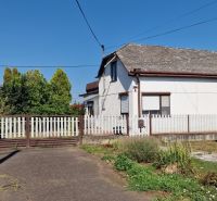 A family house on 29th August Street in Trebišov with a white wooden fence and a garden.