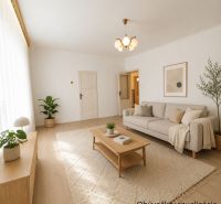 Living room in a family house with neutral furniture and a wooden decor floor.
