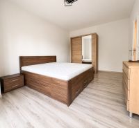 Bedroom in a 3-room apartment with wood-patterned flooring and furniture.