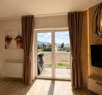 A room in a 3-room apartment with a balcony and a floor with a wooden decor.