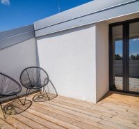 Terrace of the Recreational Apartment in Zemplínska Šírava with comfortable chairs and wooden decor.