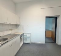 Offices with a built-in kitchenette, bright walls, compact storage spaces, practical solution.