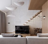 Living room in a studio apartment with a TV, stairs, and a wooden decor floor.