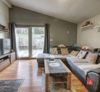 Living room in a family house with a corner sofa and a wooden decor floor.