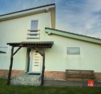 A family house in Suchá nad Parnou with an external staircase and a wooden veranda.