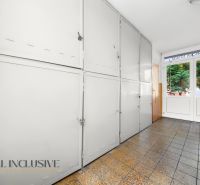 A hallway with security lockers and tiles in a 2-room apartment.