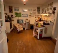 Interior of a family house with a wooden decor floor, decorative elements on the walls.