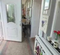 A hallway in a family house with white doors and decorations on the walls.