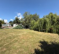 Garden with lawn and trees in the Čaradice area, suitable for residential plots.