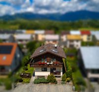 A family house in Liptovská Ondrášová on Hony Street with a garden and mountains in the background.