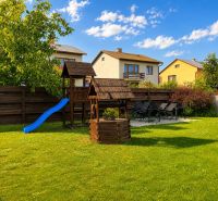 A garden with a playground and a gazebo at a family house on Hony Street in Liptovská Ondrášová.
