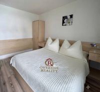 Bedroom with a bed and a wardrobe in a family house, floor with wood decor.