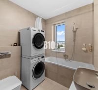 Bathroom with shower, washing machine, and dryer in a 4-room apartment, simple design.