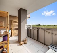 A balcony in a 4-room apartment in Nitra with a view of the surrounding countryside.