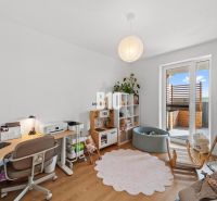 Children's room in a four-room apartment with a wooden decor floor and a play corner.