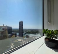 View from the window in Bratislava (Old Town) of the skyline with buildings and greenery.
