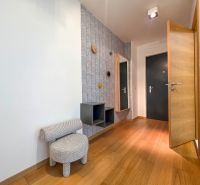 Interior of a 1-room apartment with a decorative wall and floor with a wood decor.