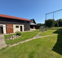 A family house in Liptovské Kľačany with a yard, swings, and a manicured lawn.