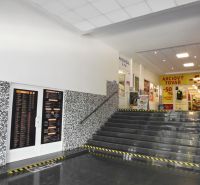 In the offices, there is a staircase with tiled flooring and mosaic decoration on the wall.