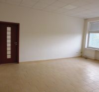 Spacious offices with tiles and a window providing natural light.